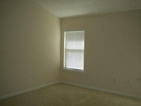 Jacksonville house for rent - A room with a window covered by white blinds.