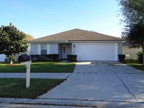 Jacksonville house for rent - A house with a brown roof and a white garage door.