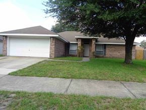 Jacksonville house for rent - A house with a garage and a tree in front.