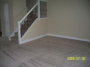 Jacksonville house for rent - A staircase with a black railing and white handrails.