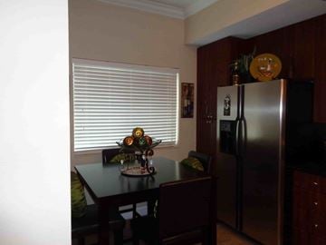 Jacksonville house for rent - A kitchen with a table and chairs and a refrigerator.