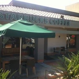 Vista apartment for rent - A green umbrella is in front of a Starbucks Coffee.