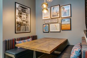 Seattle apartment for rent - a dining room with pictures on the wall and a wooden table