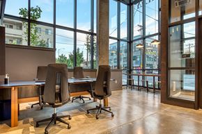 Seattle apartment for rent - a conference room with large windows and desks and chairs