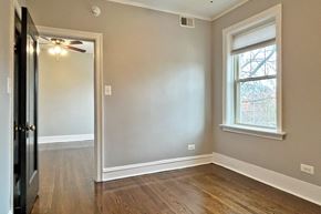 Oak Park apartment for rent - A room with a window and a ceiling fan.