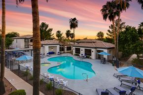 Phoenix apartment for rent - a swimming pool with chairs and umbrellas at sunset