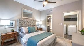 Mckinney apartment for rent - a bedroom with a bed and a ceiling fan