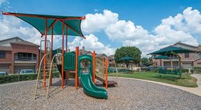 Mckinney apartment for rent - a childrens playground with a swing set