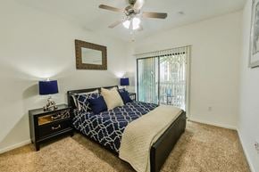 The Woodlands apartment for rent - a bedroom with a bed and a ceiling fan