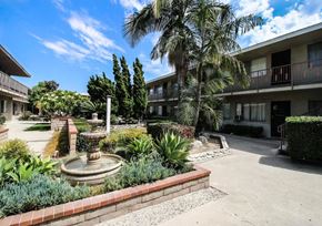 Downey apartment for rent - a courtyard with a fountain and palm trees