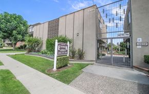 Downey apartment for rent - the front of a building with a sign in front of it