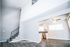 Huntington Beach apartment for rent - a living room with a ceiling fan and a staircase