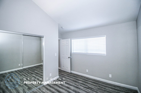 Huntington Beach apartment for rent - a bedroom with a closet and a door and a window