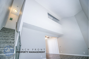Huntington Beach apartment for rent - a view of a stairwell from the top of a staircase with a white wall