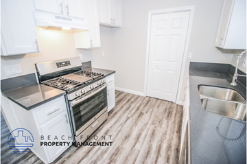 Huntington Beach apartment for rent - a renovated kitchen with white cabinets and stainless steel appliances