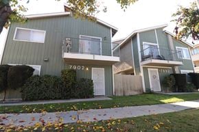 Huntington Beach apartment for rent - a green house with a sidewalk in front of it
