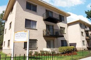 Washington apartment for rent - an apartment building with a sign in front of it