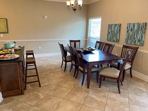 Orange apartment for rent - a dining room with a wooden table and chairs