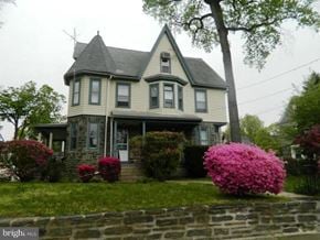 Narberth apartment for rent - an old house with pink flowers in front of it