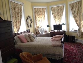 Narberth apartment for rent - a bedroom with a bed and three windows