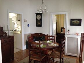 Narberth apartment for rent - a dining room with a table and chairs and a clock on the wall