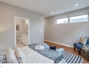 Philadelphia house for rent - a bedroom with a bed and a bathroom with a sink