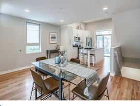 Philadelphia house for rent - an open kitchen and dining room with a table and chairs