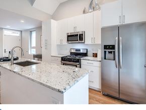 Philadelphia house for rent - A modern kitchen with a granite countertop and stainless steel appliances.