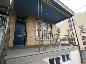 Philadelphia house for rent - A balcony with a metal railing and a blue door.