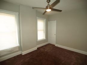 Philadelphia house for rent - A room with a ceiling fan and a door.