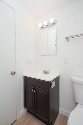 Philadelphia apartment for rent - a bathroom with a toilet and a sink and a mirror