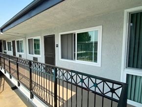 Glendale apartment for rent - a balcony of a building with windows and a black railing