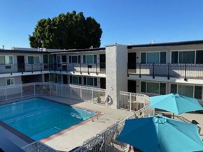 Glendale apartment for rent - a swimming pool and a building with umbrellas