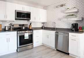 Newport apartment for rent - a white kitchen with stainless steel appliances and white cabinets