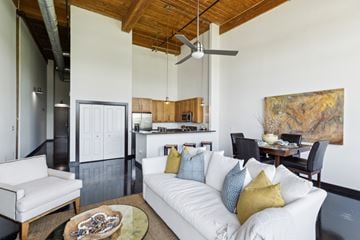 Greenville apartment for rent - A living room with a white couch and a ceiling fan.