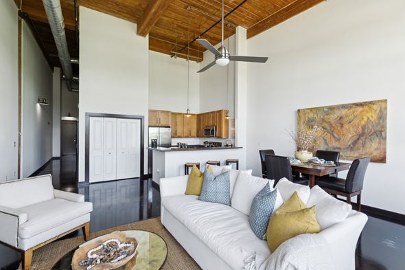 Greenville apartment for rent - A living room with a white couch and a ceiling fan.