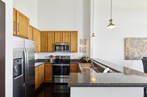 Greenville apartment for rent - A kitchen with wooden cabinets and a granite countertop.