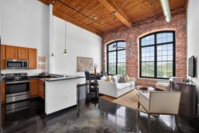 Greenville apartment for rent - A kitchen with a white counter top and a black stove top oven.
