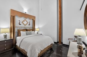 Greenville apartment for rent - A bedroom with a large bed and a wooden headboard.