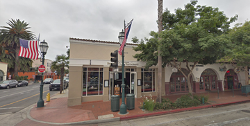 Santa Barbara apartment for rent - A street view of a building with a red awning and a sign that reads "Peninsula".