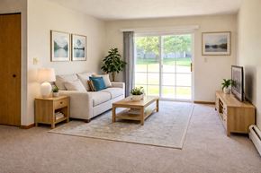 Mason City apartment for rent - A living room with a couch, a coffee table, and a television.