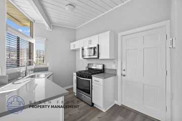 Redondo Beach apartment for rent - A kitchen with white cabinets and a stove top oven.