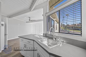 Redondo Beach apartment for rent - A modern kitchen with a stainless steel sink and a ceiling fan.