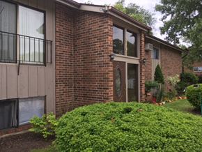 Mchenry apartment for rent - the front of a brick house with a yard and a glass door