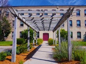 Grand Ledge townhouse for rent - a covered walkway in front of a building with a red door