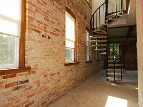 Grand Ledge townhouse for rent - a brick wall with a spiral staircase next to it