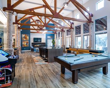 Clubhouse game room with pool table and exposed beams