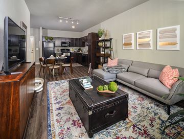 Arlington apartment for rent - A living room with a grey couch and a wooden cabinet.