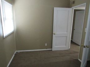 Peoria house for rent - A room with a white door and carpeted floor.