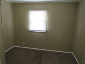 Peoria house for rent - A room with a window and brown carpet.
